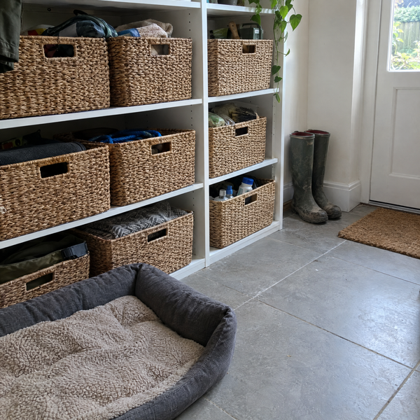 Woven storage baskets on shelves in a utility room